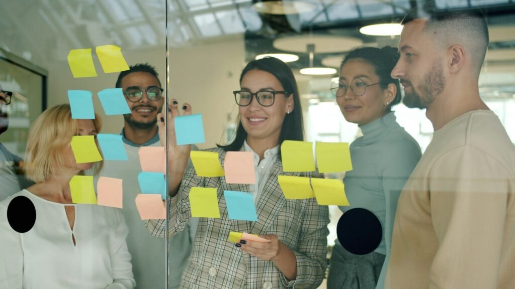 A strategy session with sticky notes on a glass wall